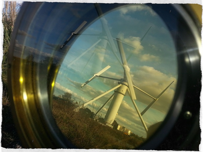 A look at a wind turbine through a magnifying glass